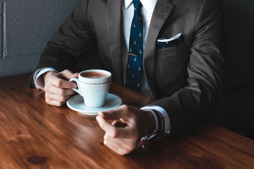 businessman black suit tie drinking